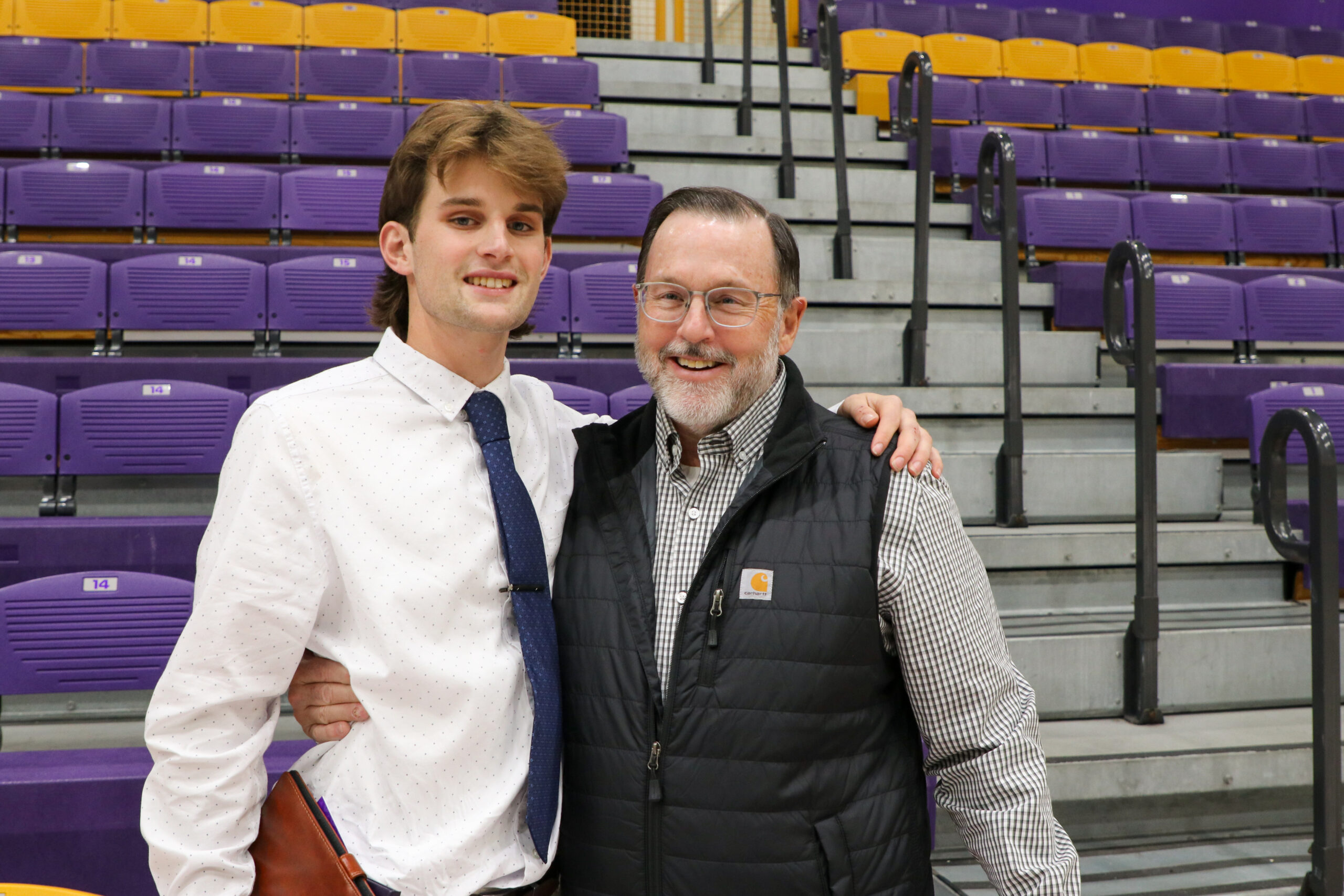 Two men embracing after graduation ceremony