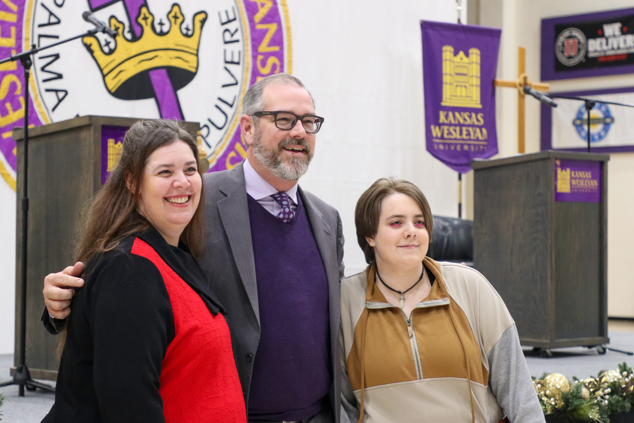 Staged photo of two women with man