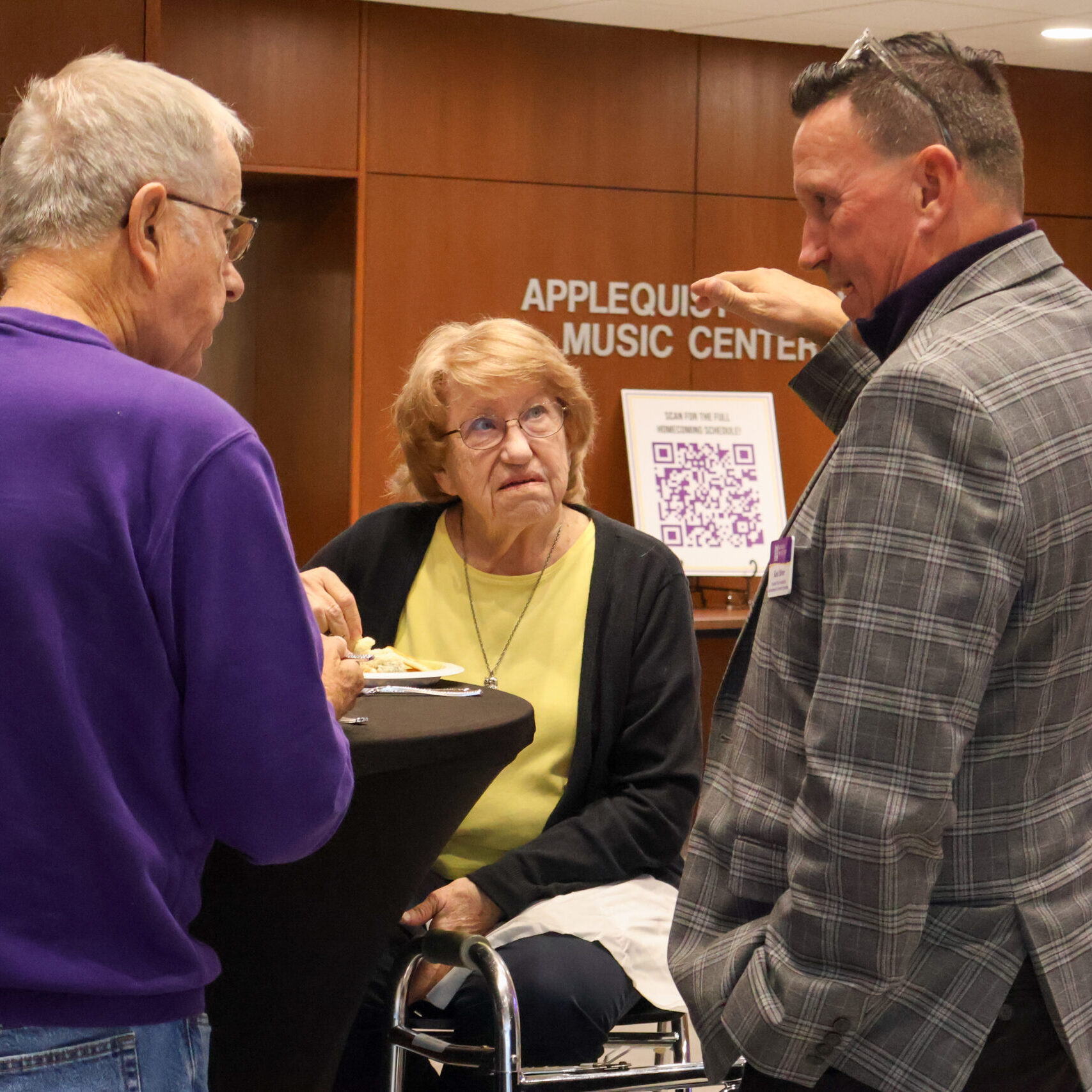 Group of individuals talking, all standing