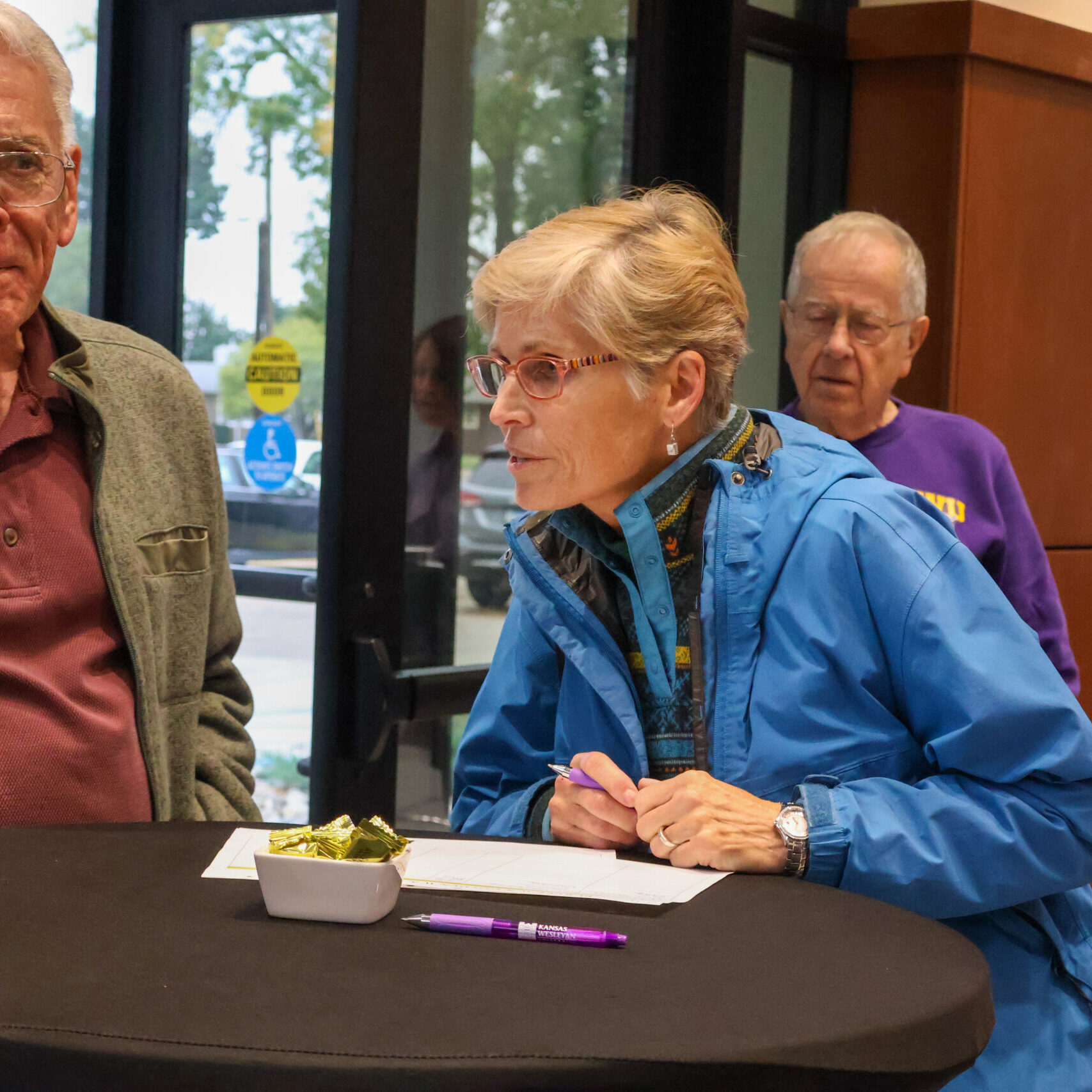 Woman signing document on table