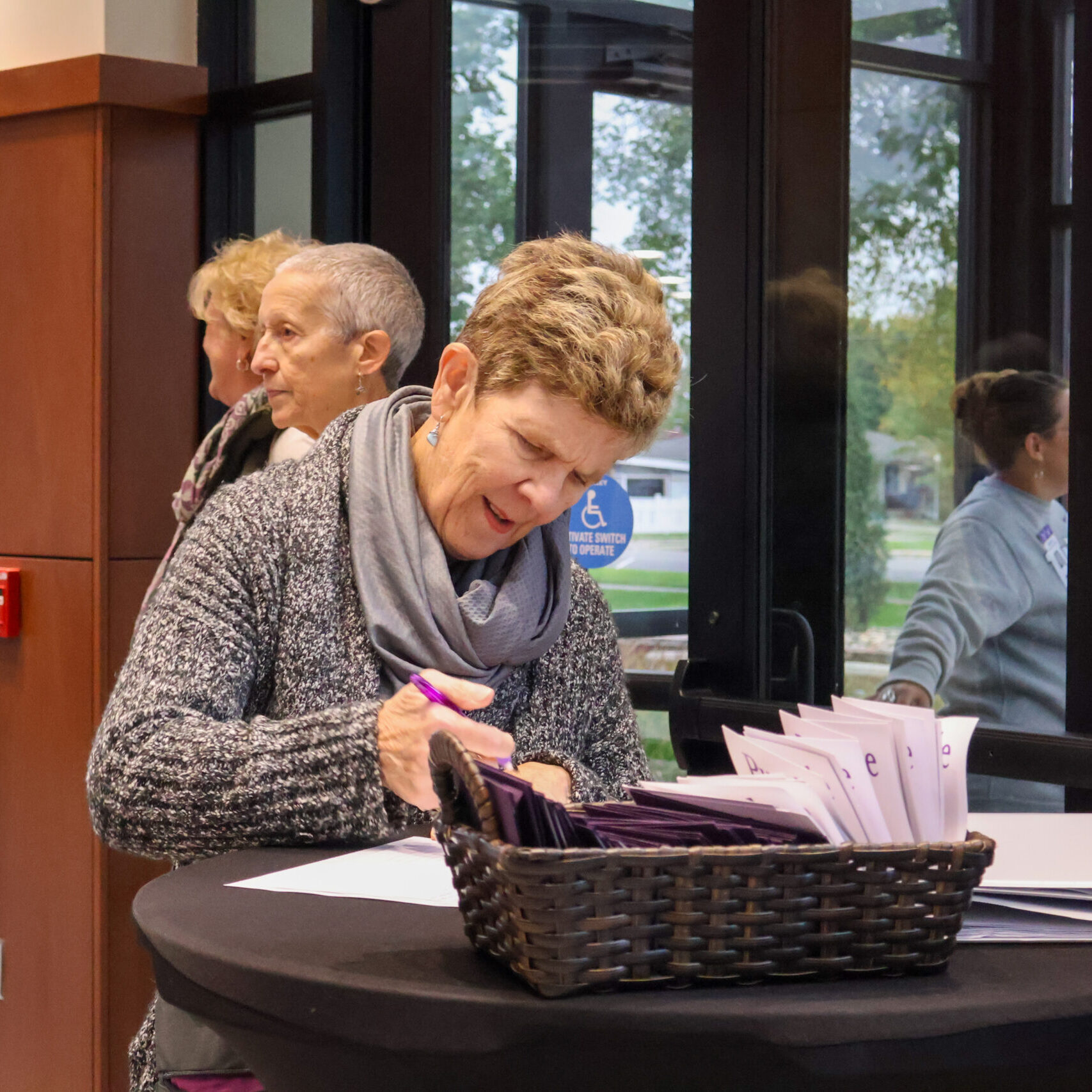 Woman signing document on table