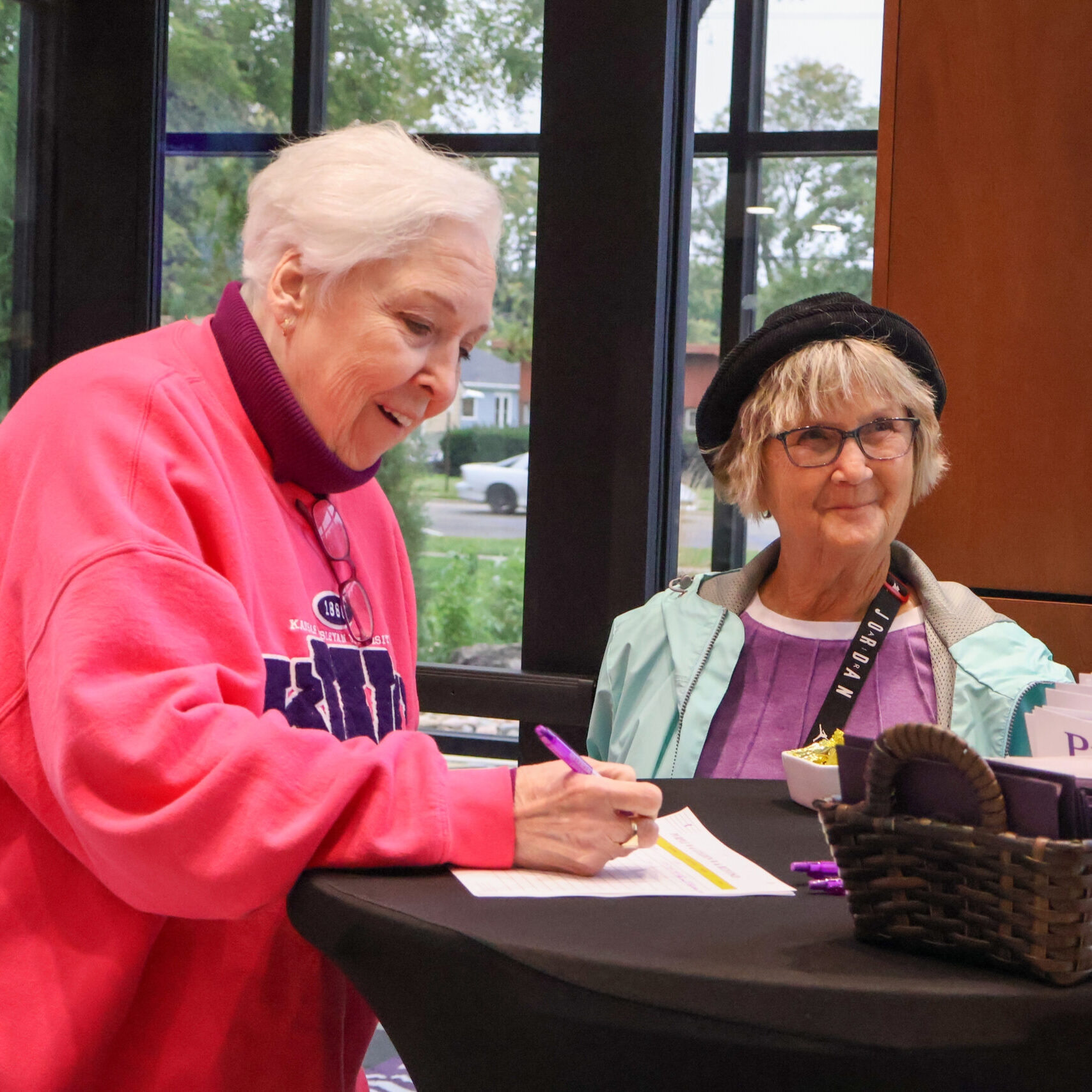 Woman signing document on table