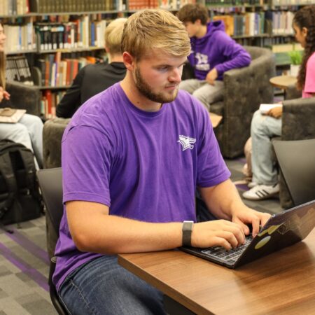 Student on laptop in library