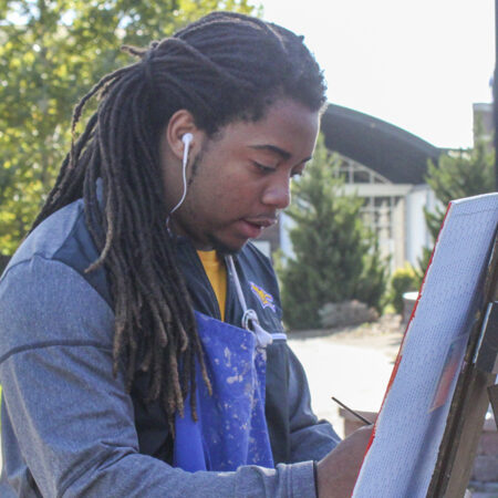 Student painting outside