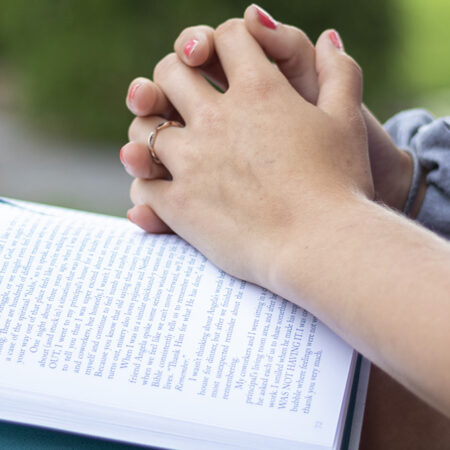 Student with hands on book