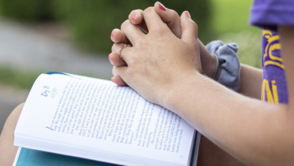 Student with hands on book