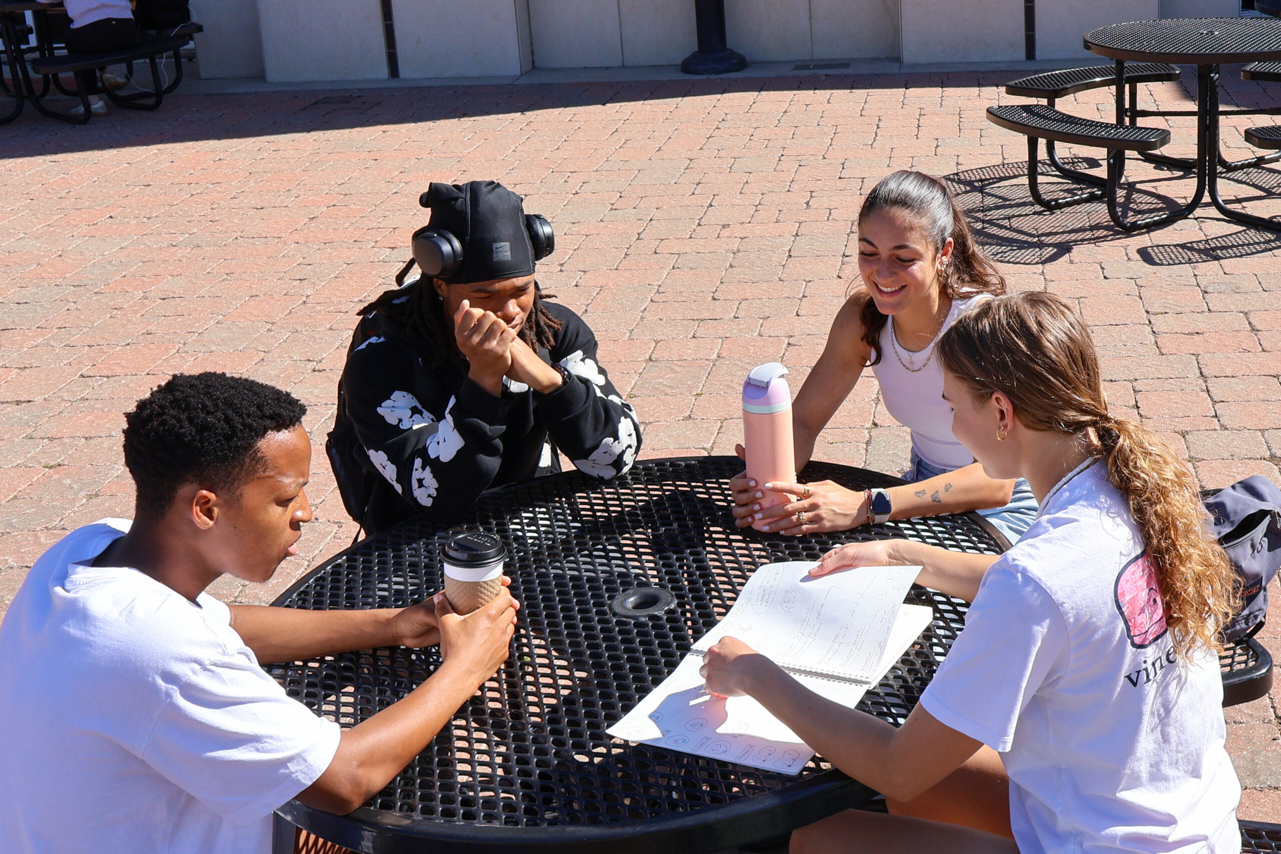Students sitting at a table outside