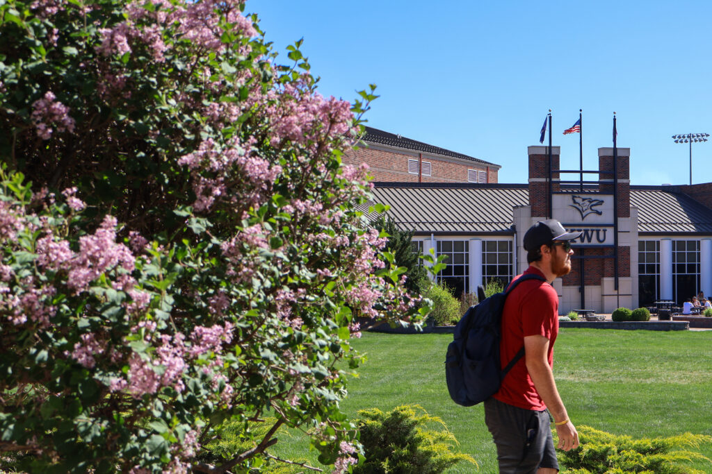 Student waling by Student Activity Center