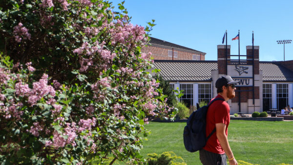 Student waling by Student Activity Center