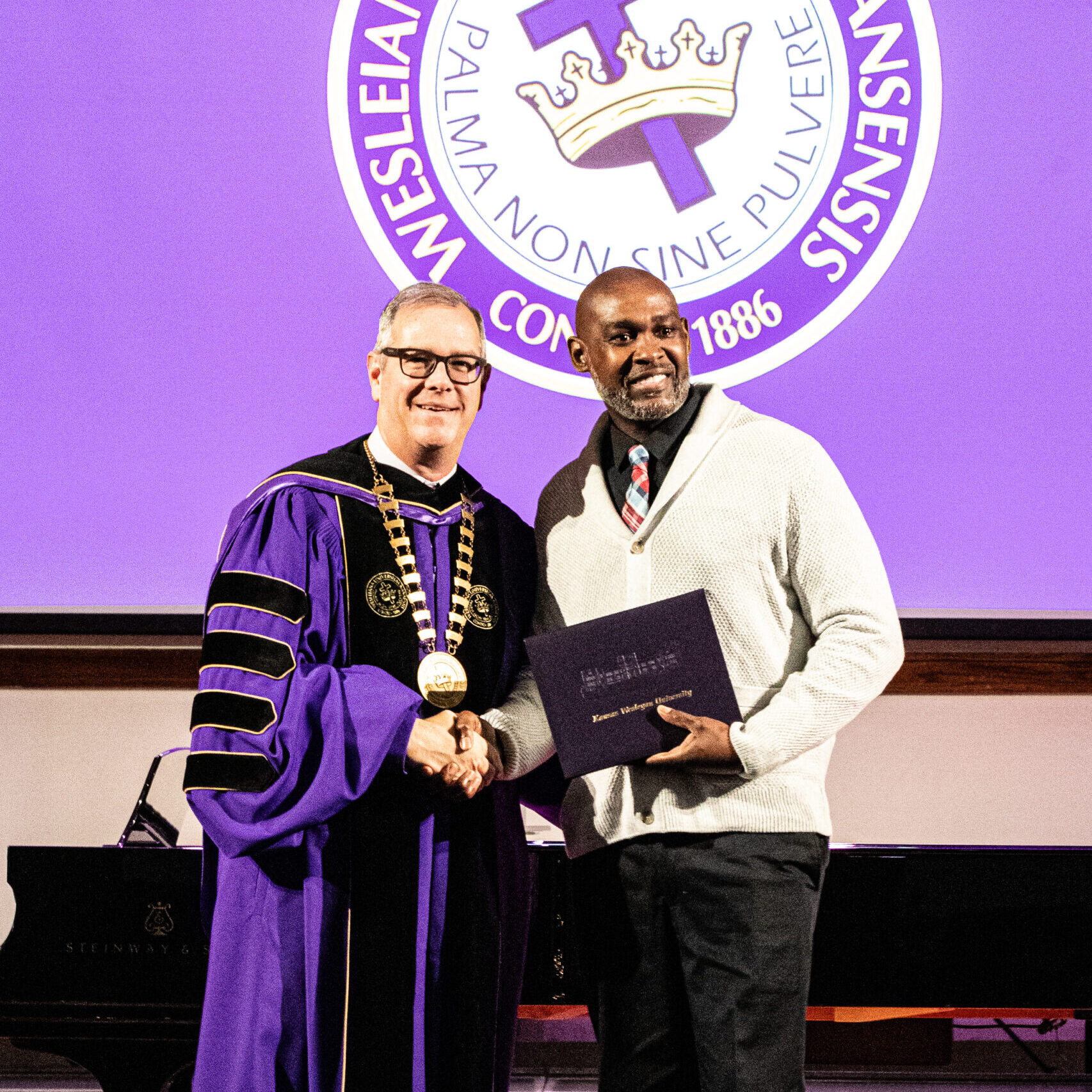 Man with diploma and president