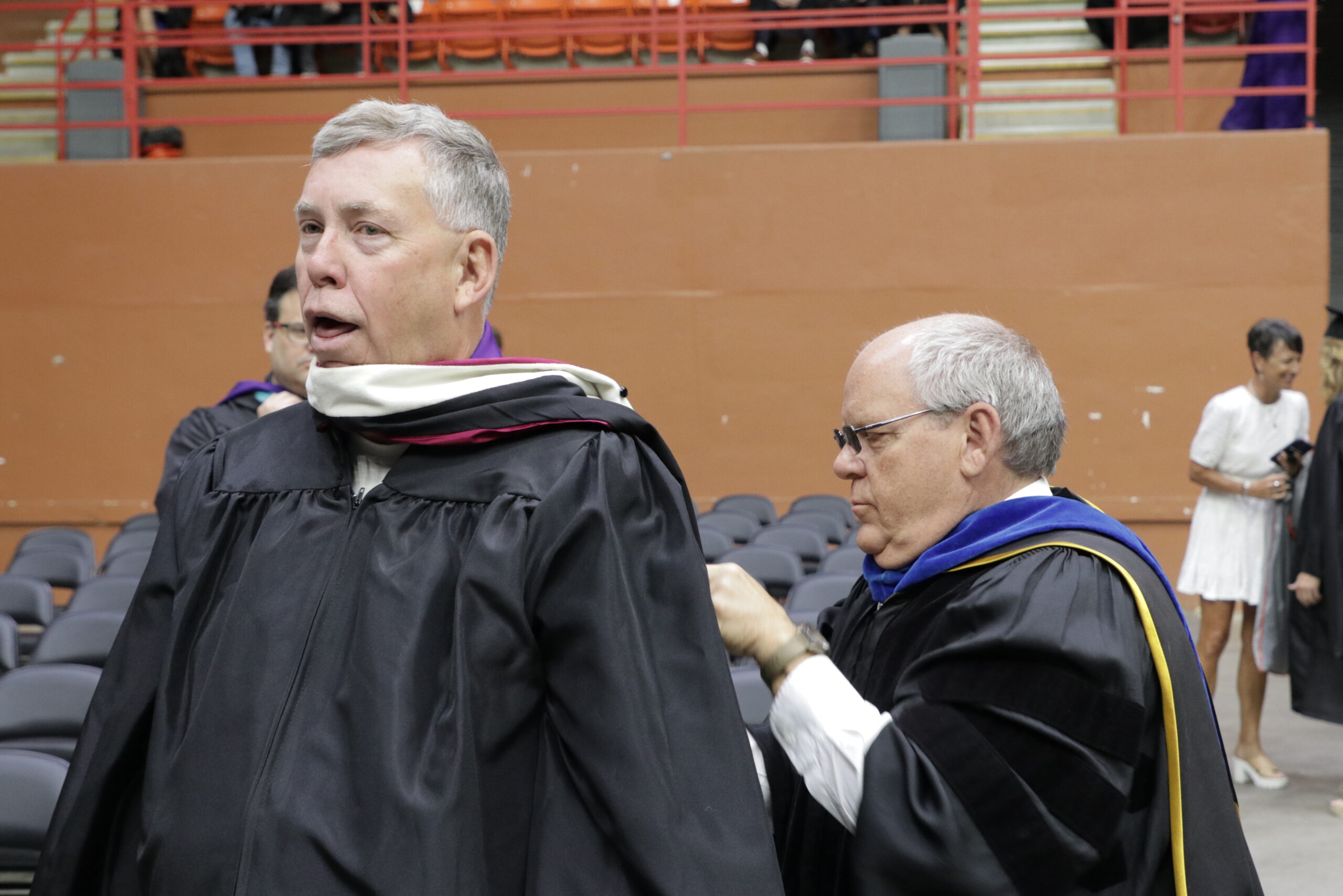 Man pretending to be strangled by gown