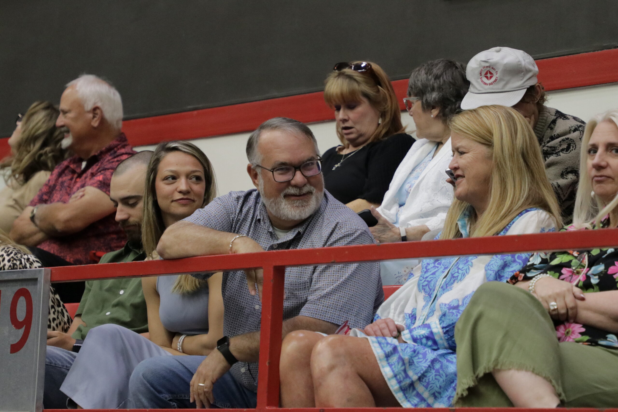 Man talking to woman while in arena seat