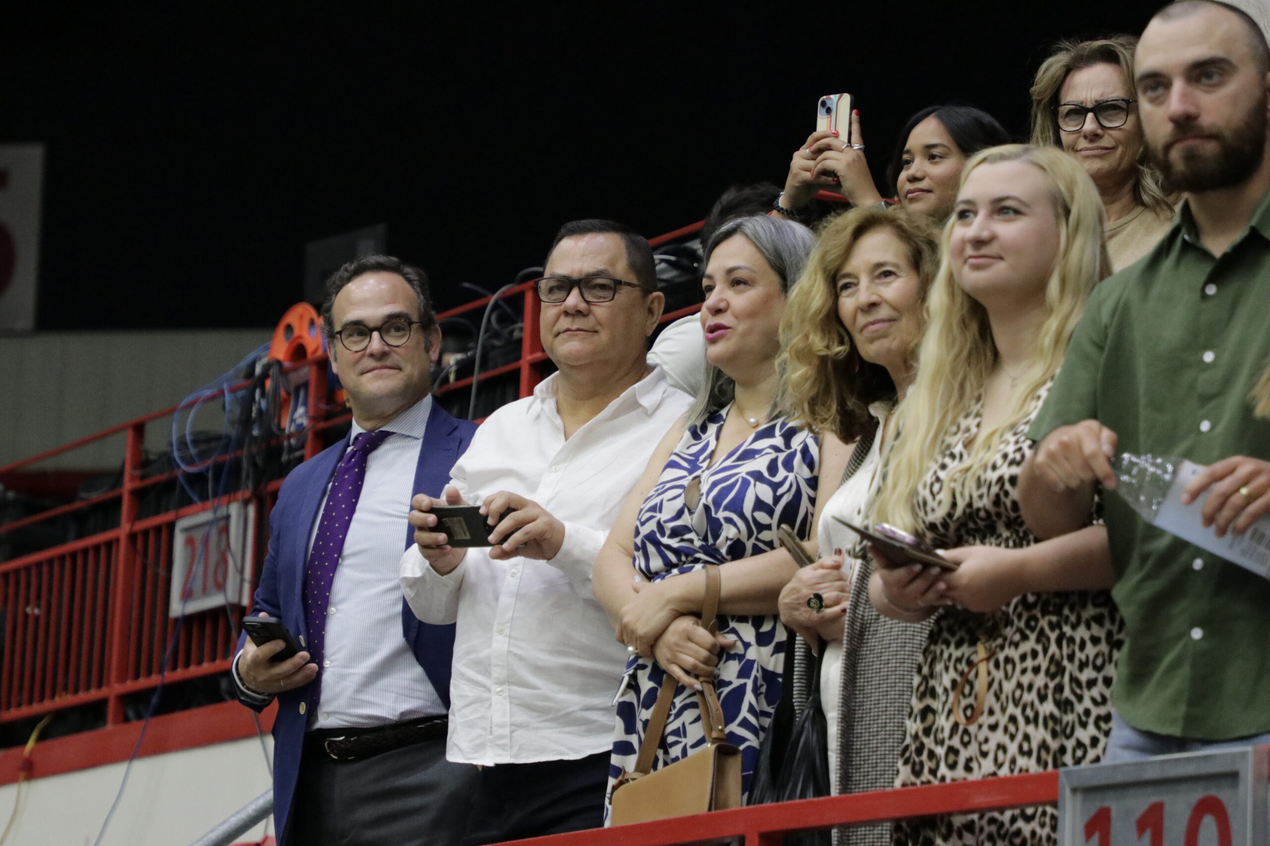Various people watching graduation ceremony