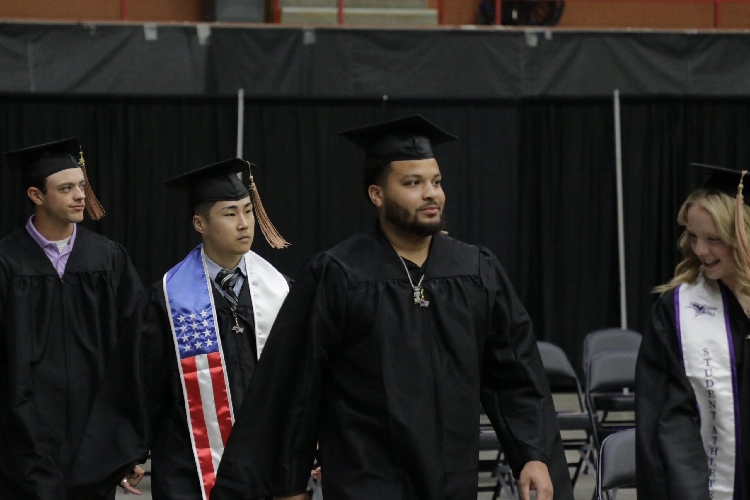 Row of men in cap and gown