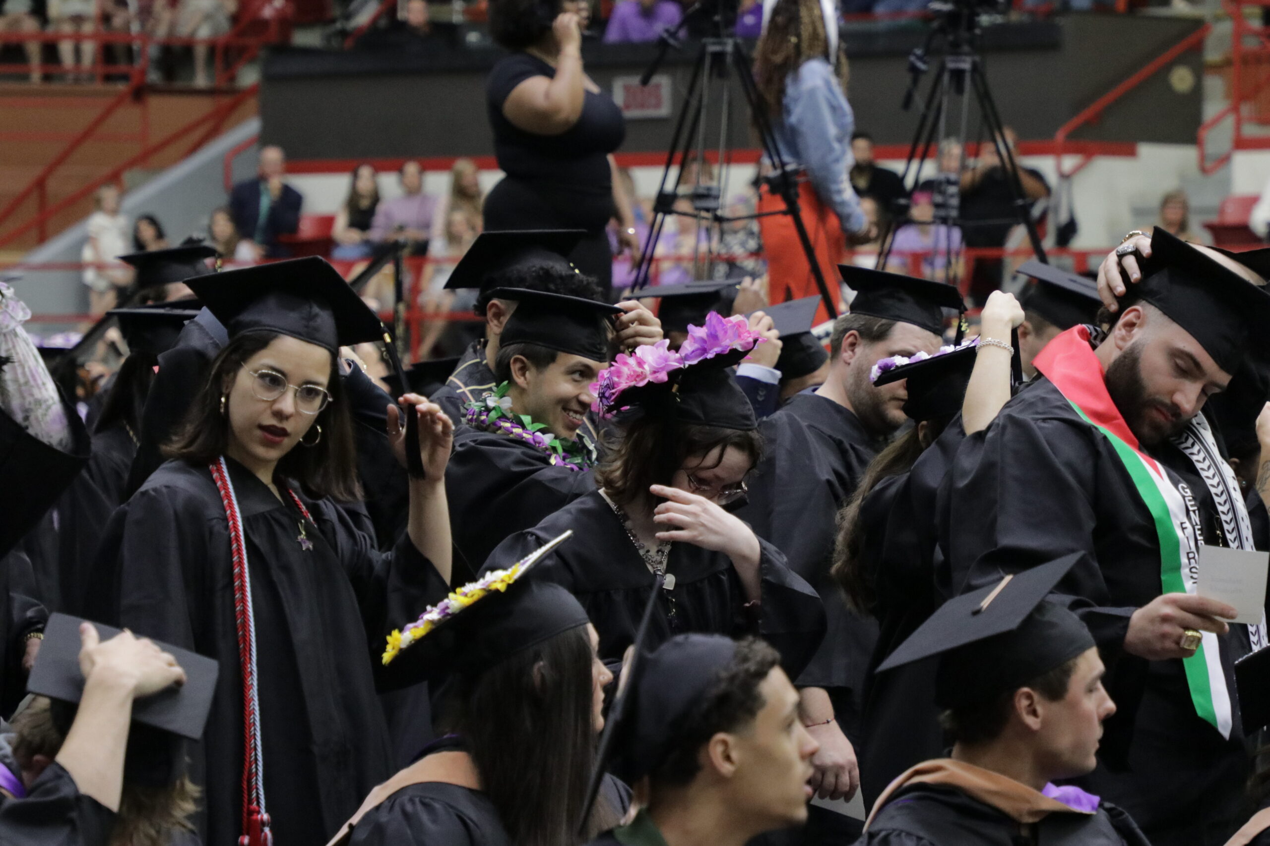 Graduates moving tassels to other side of cap