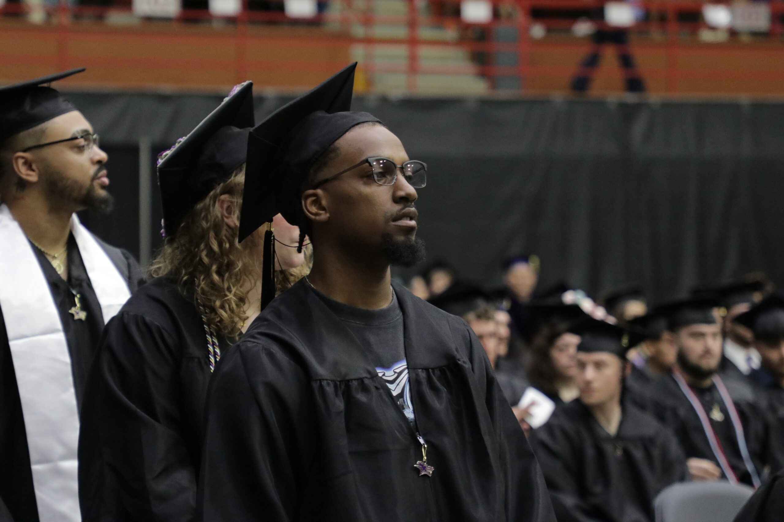 Man in graduation gear walking