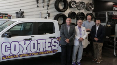 Four men in front of truck