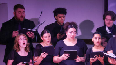 Group of people singing in concert dress
