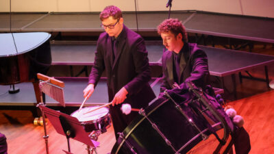 Two men playing percussion instruments