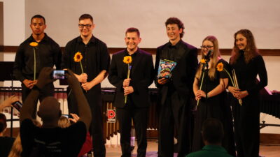 Percussion ensemble group together on stage