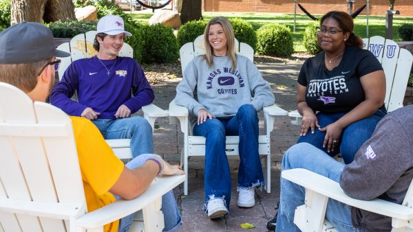 Students sitting in chairs outside