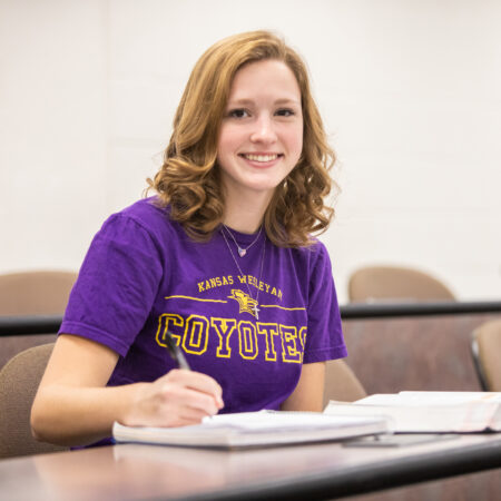 Woman with textbook in classroom