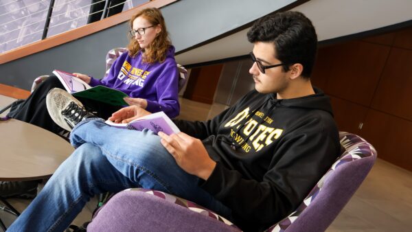 Two students reading in lobby