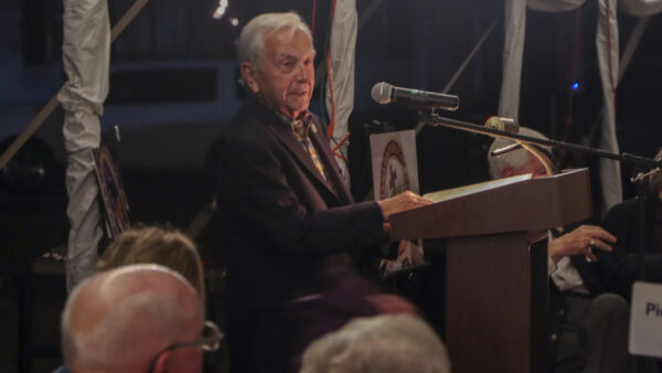 Man standing at podium talking