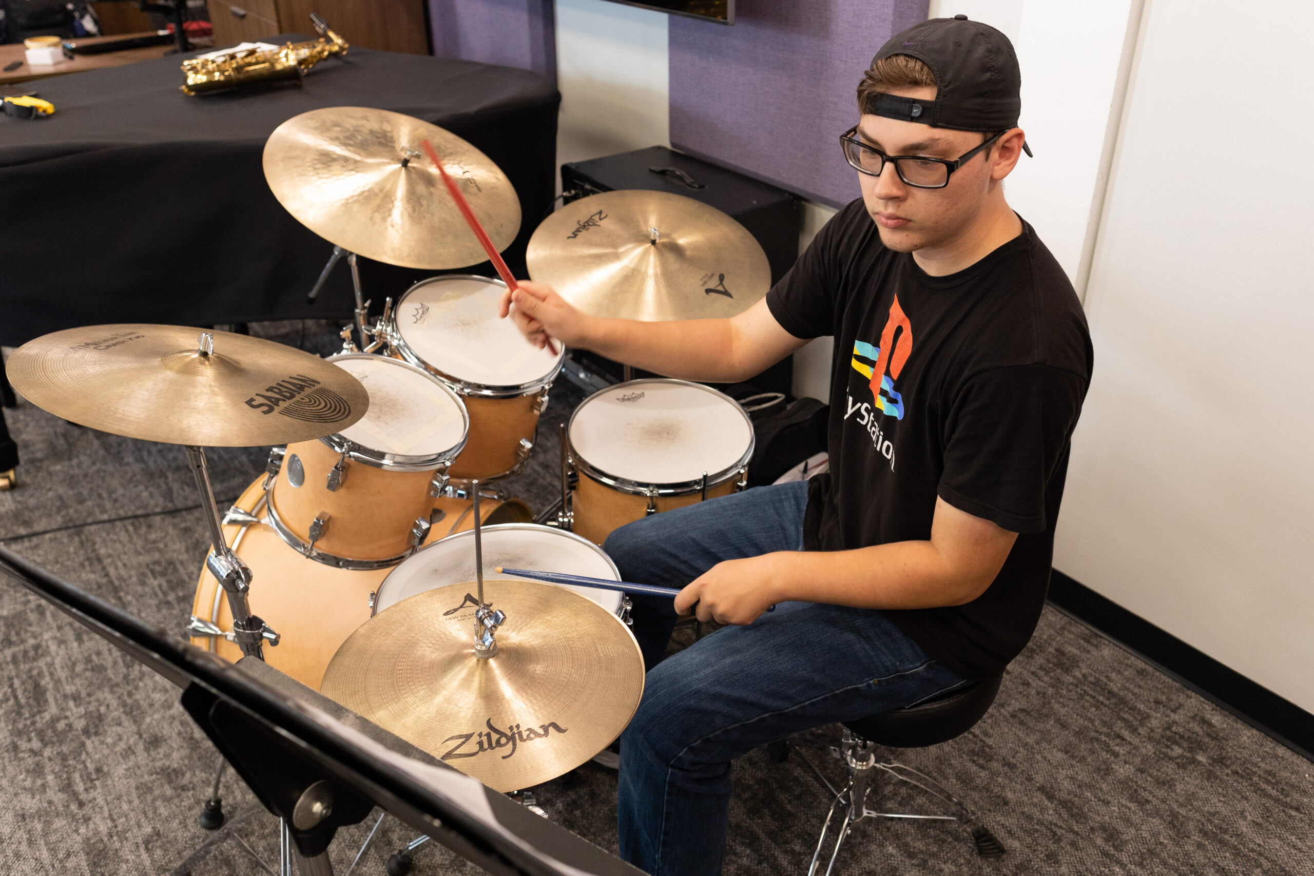Student practicing on drums.