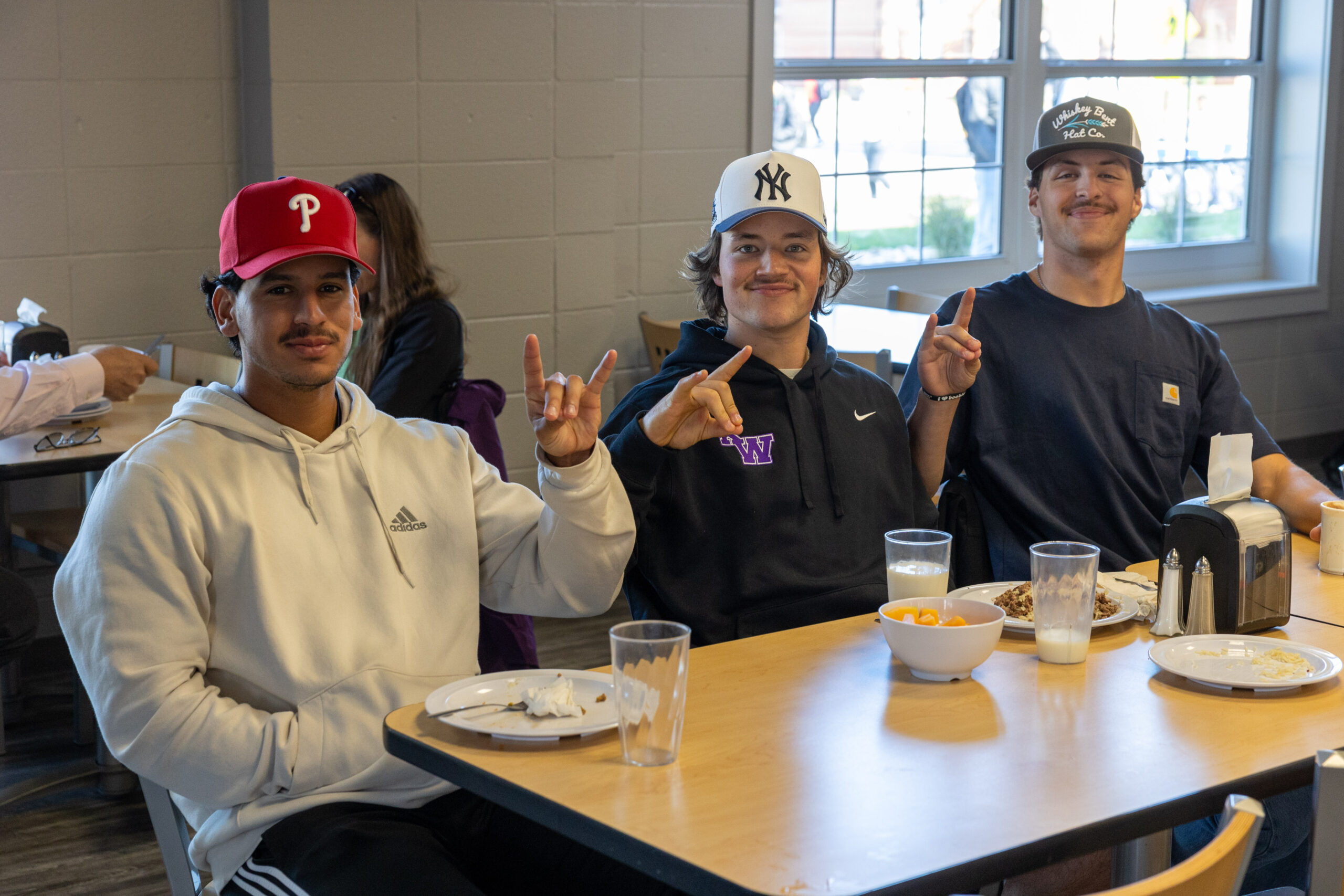 Three students pose for photo in dining hall