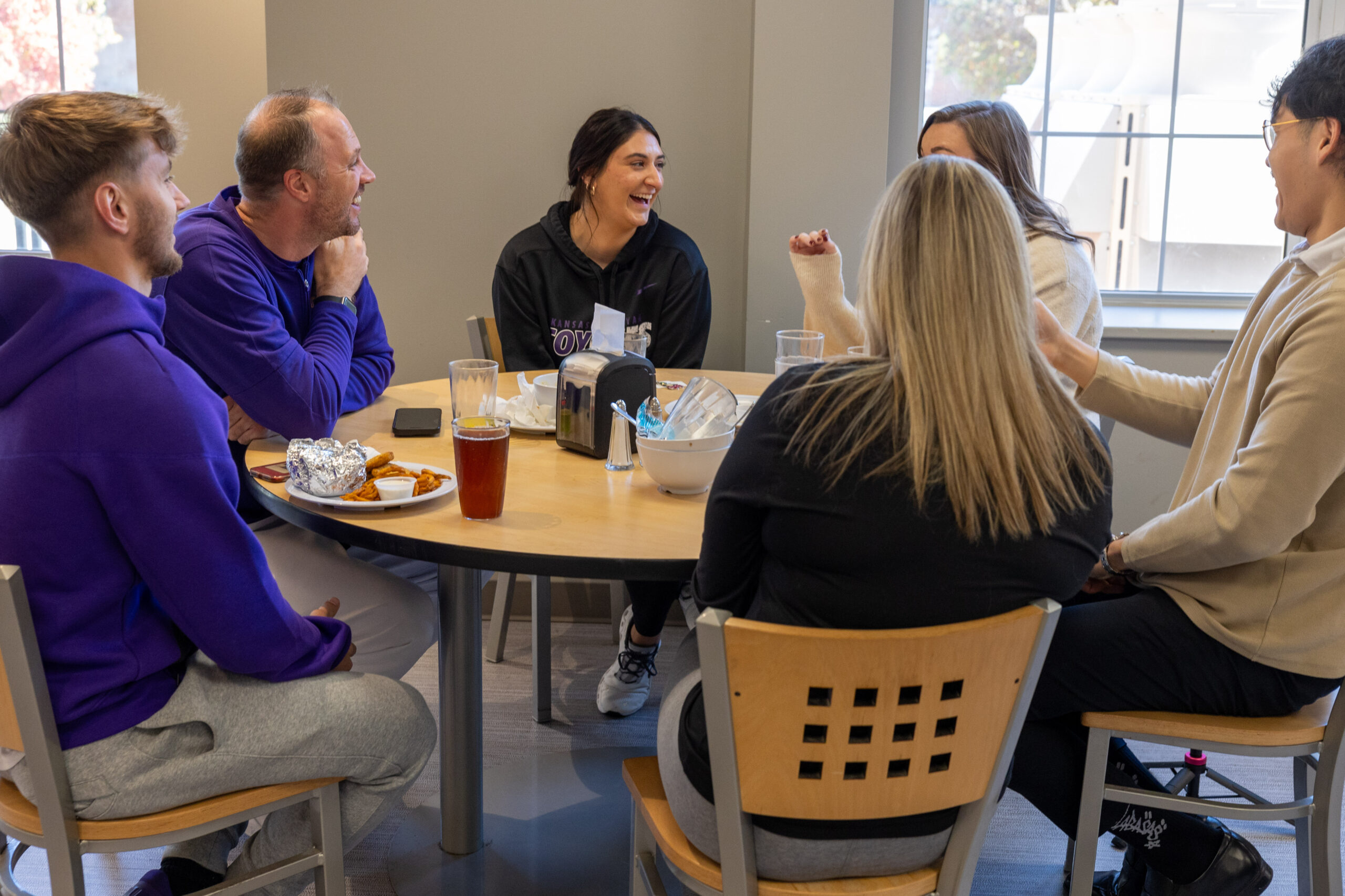 People laughing and enjoying lunch in dining hall