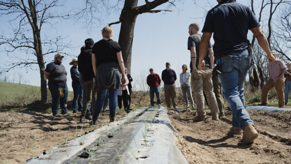 Group of people talking at farm