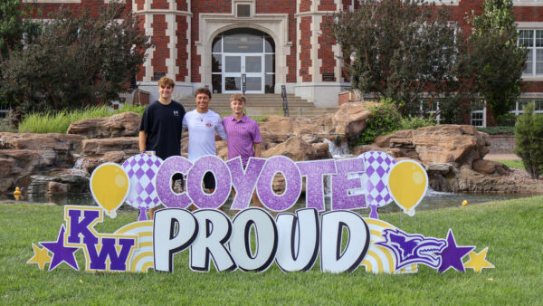Family behind sign