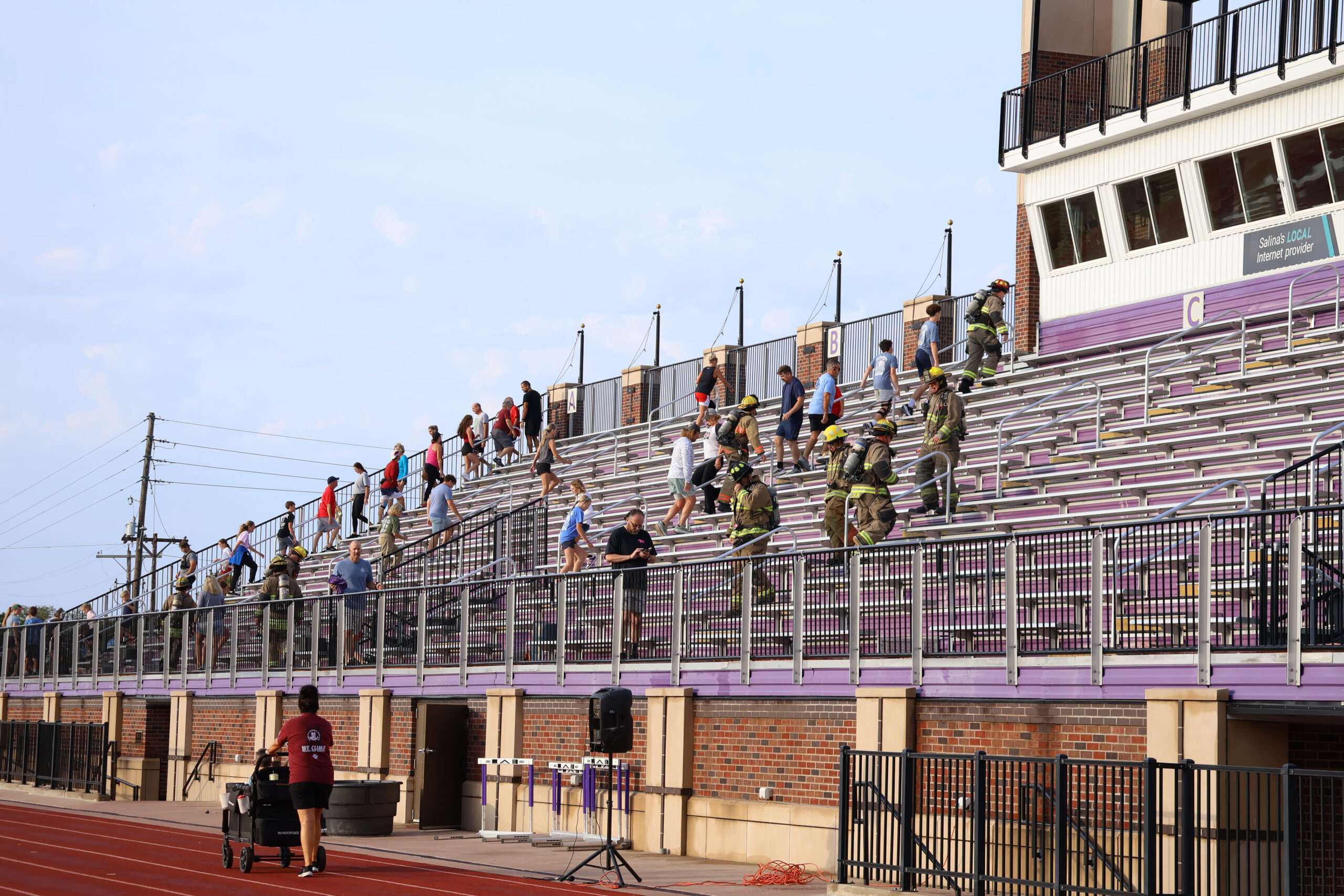 Group of people climbing stadium stairs