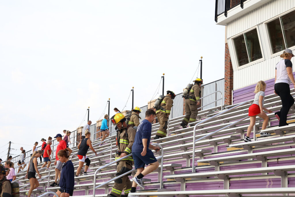 Group of people climbing stadium stairs