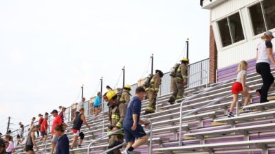 Group of people climbing stadium stairs