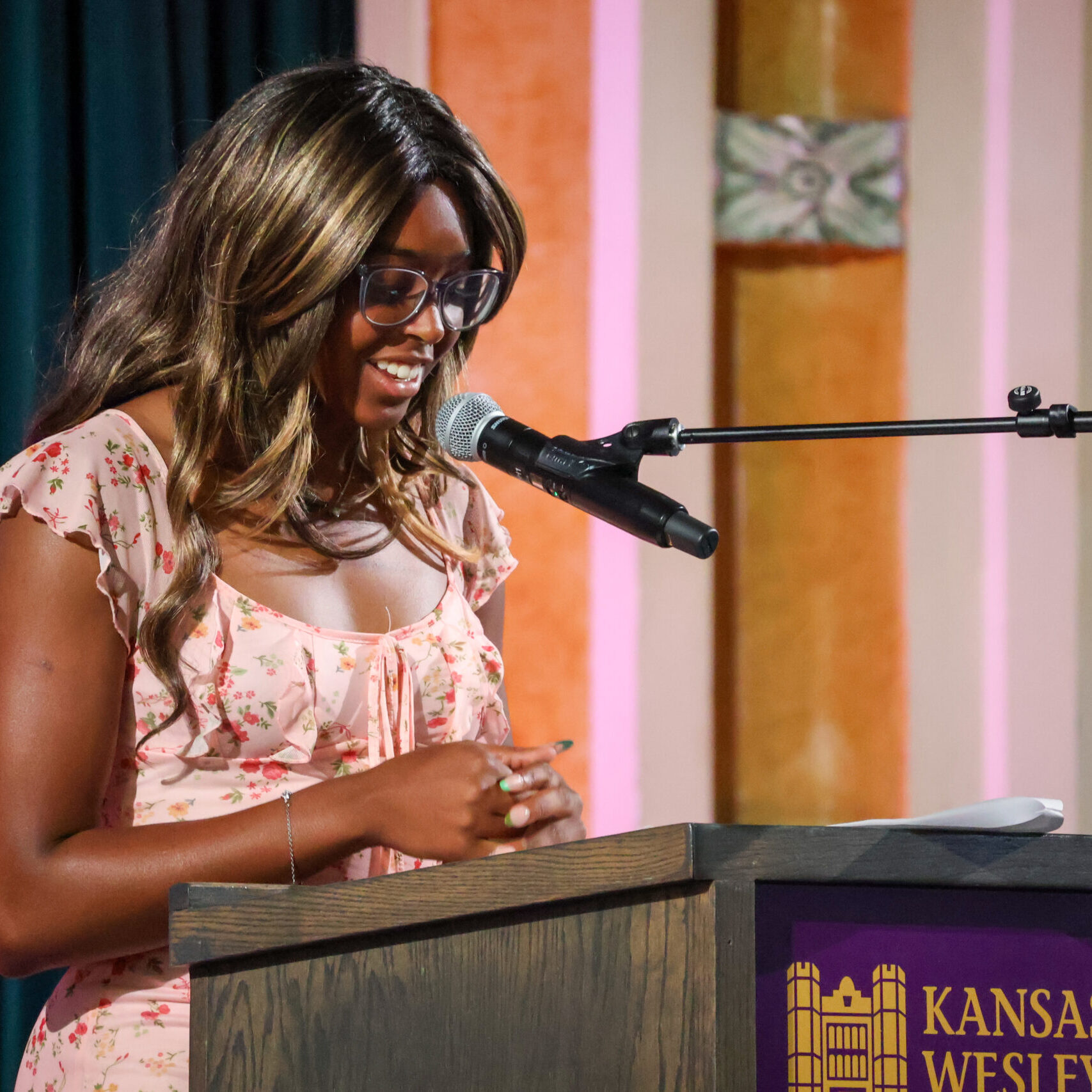 Woman reading speech on stage