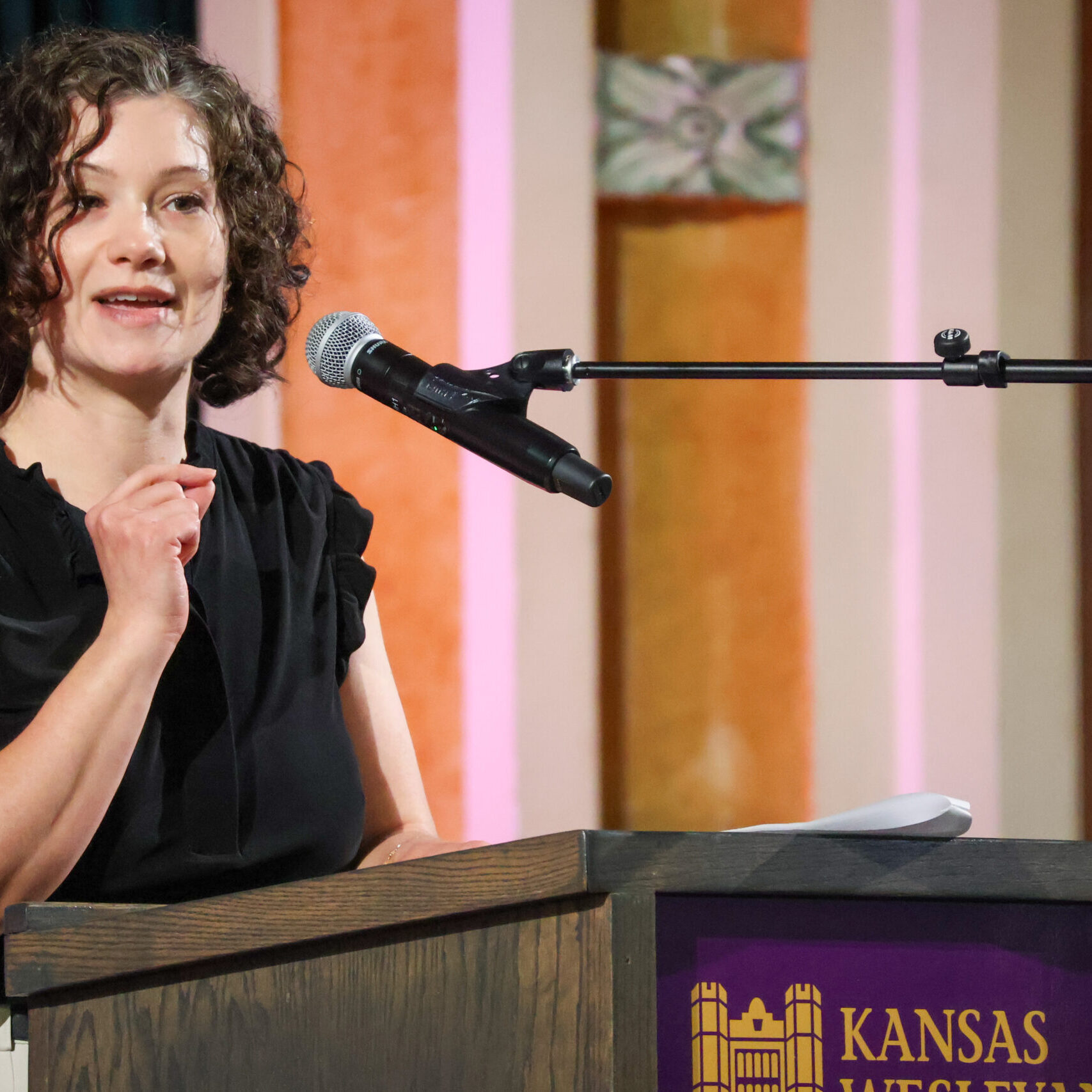 Woman giving speech on stage