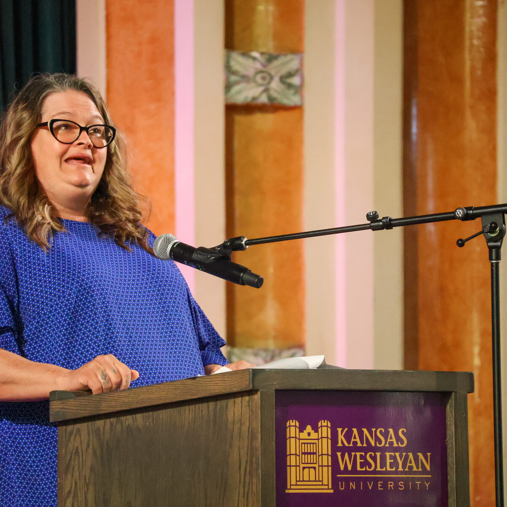 Woman giving speech on stage
