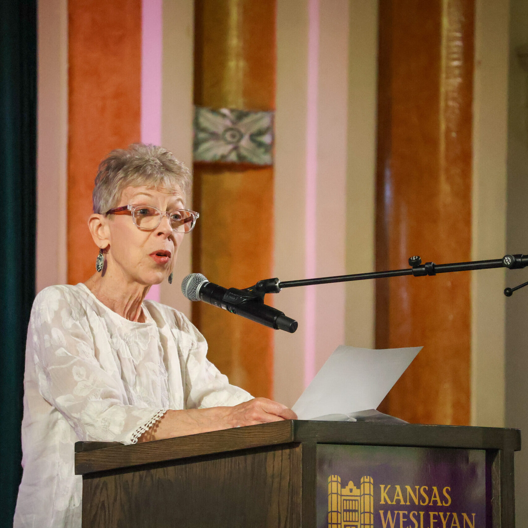 Woman reading speech on stage