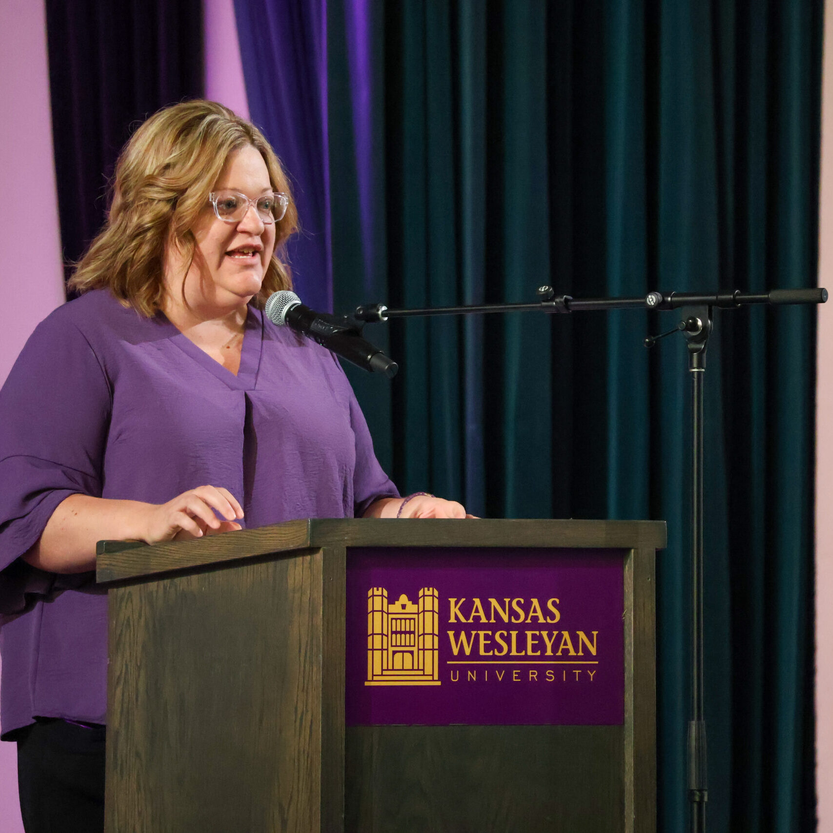 Woman reading speech on stage