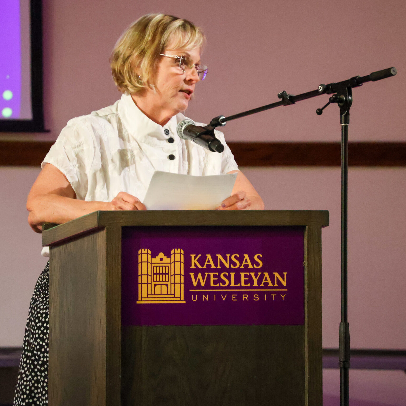 Woman reading speech on stage