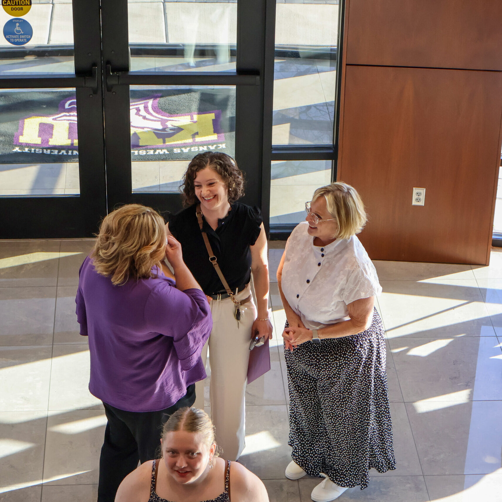 Group of women talking in facility entryway