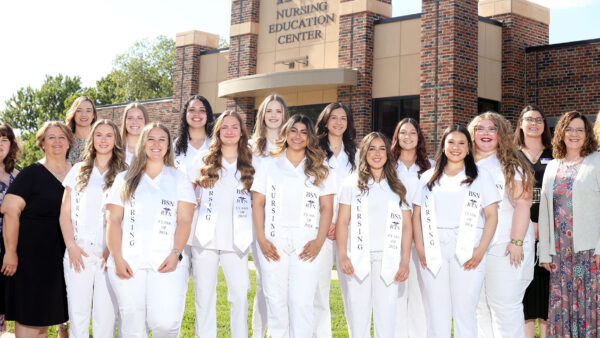 Individuals in nursing gear with faculty