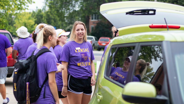 Students helping move people in