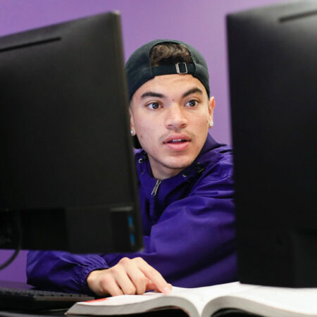 Student with book and computer