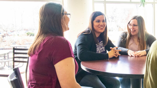 Woman talking with female students