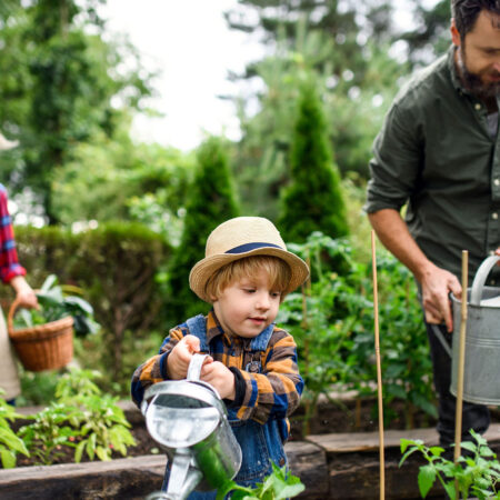 Kid watering garden