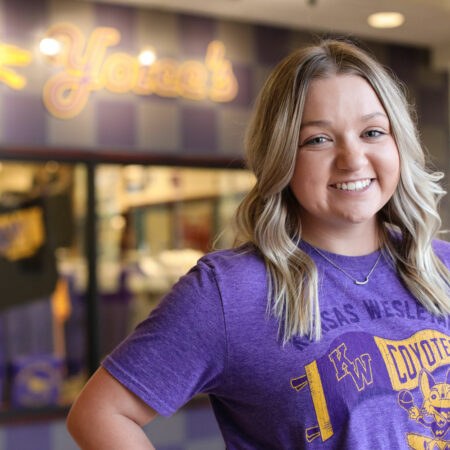 Female student standing in front of spirit store